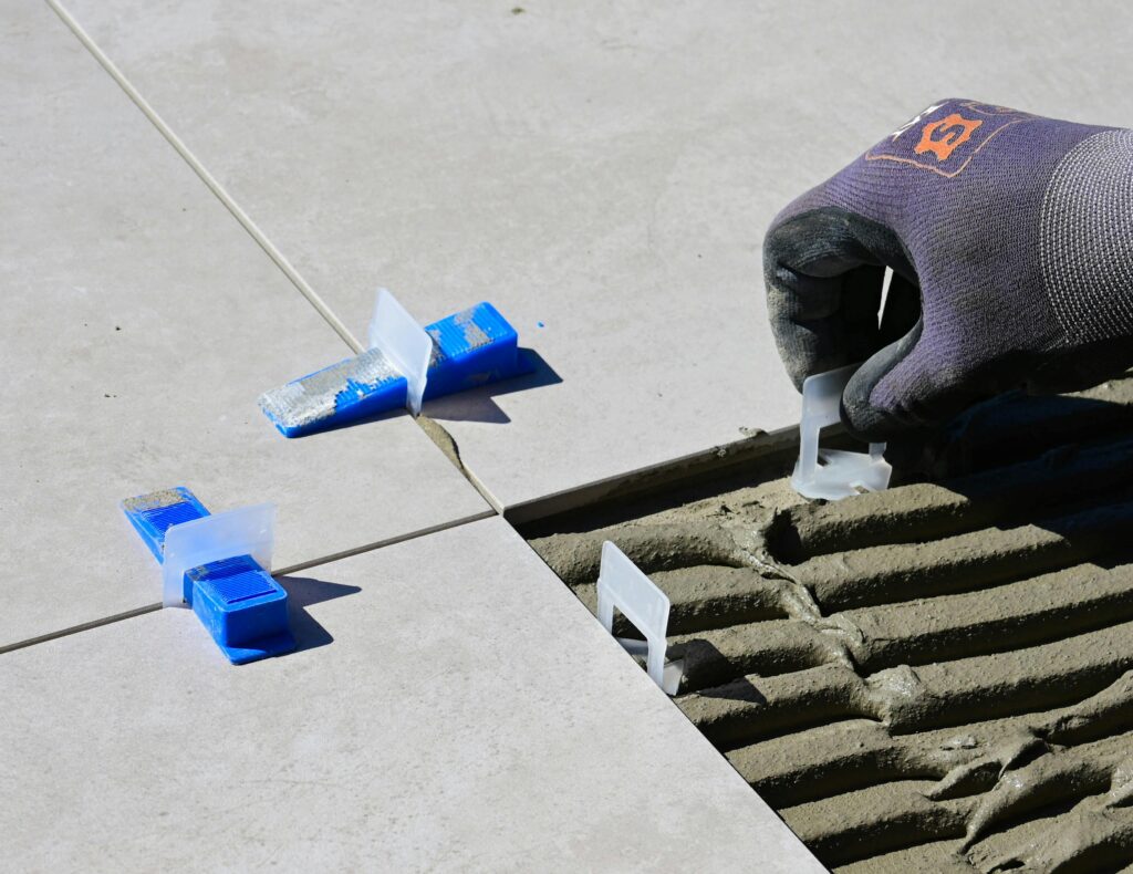 Tile leveling clips and tools used during floor tile installation